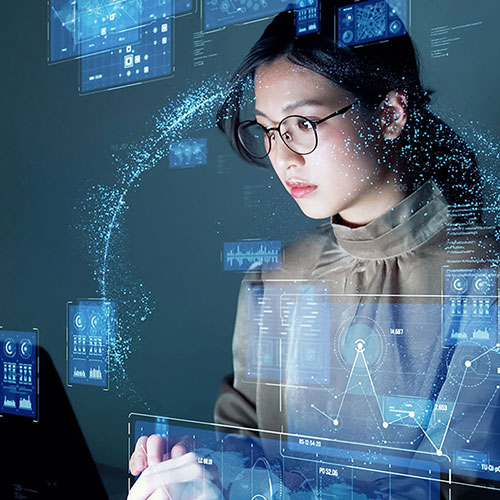 woman looking at computer with code graphics overlayed on photo