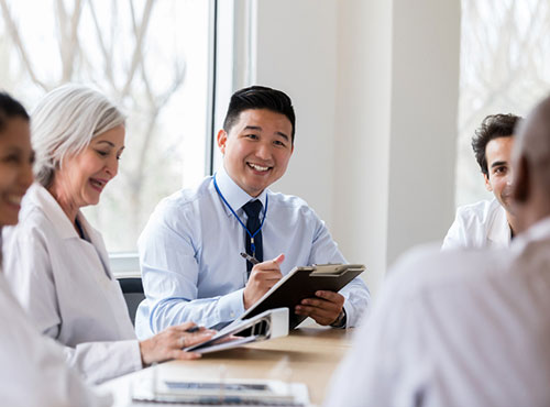 Health professionals in a meeting around a conference table