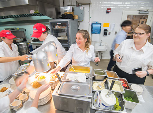 Chef and workers in restaurant kitchen