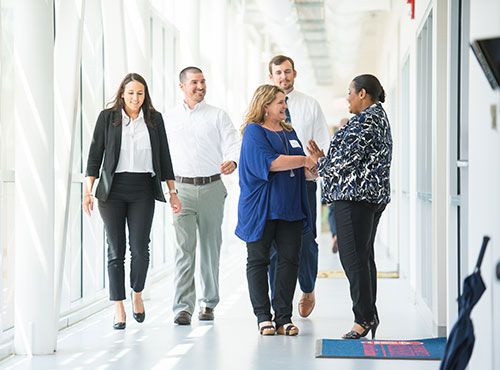 Group of business people meeting in a hallway