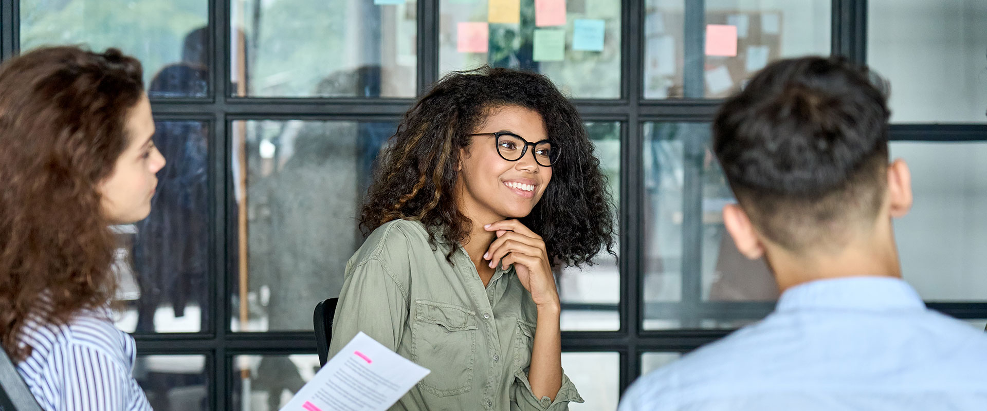 Woman speaking to other business people