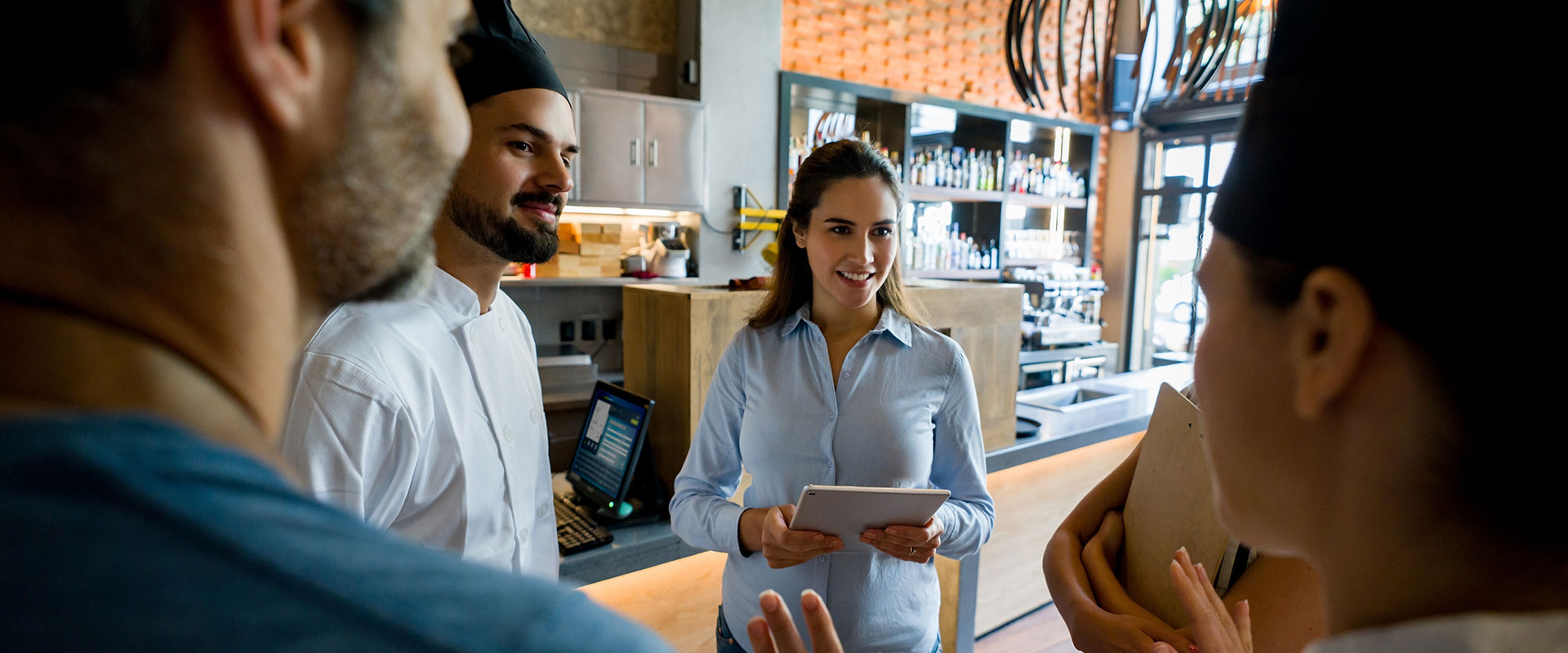 Woman in restuarant kitchen with staff