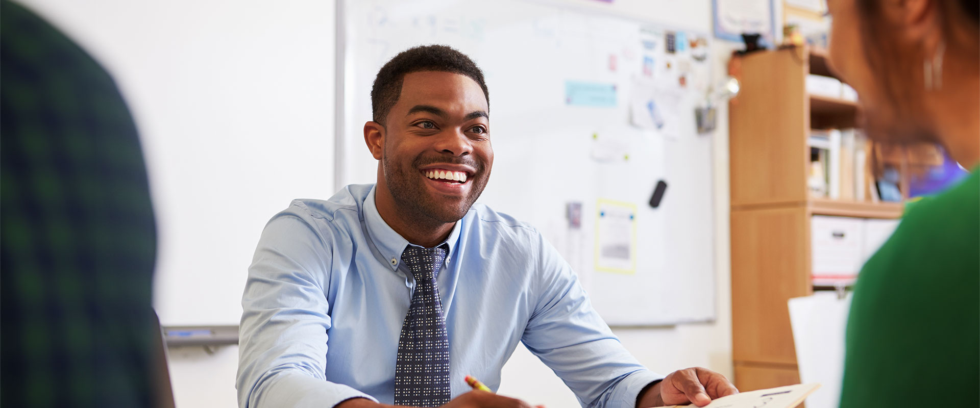 Student in office wearing jacket looking relaxed