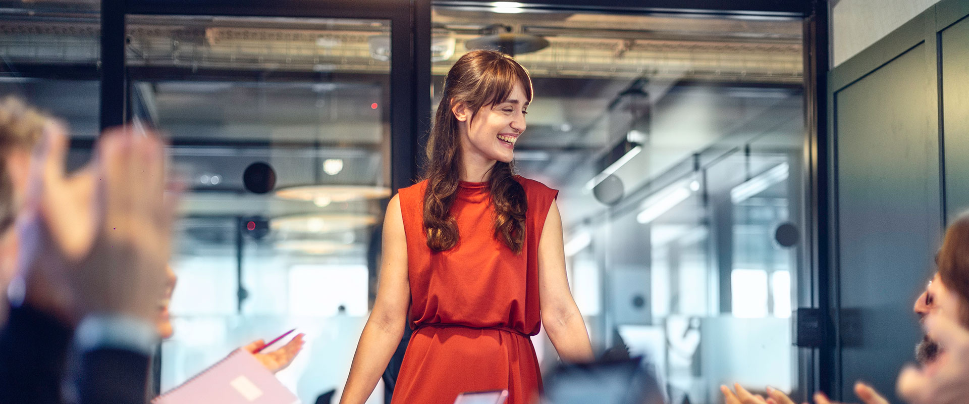 Woman in board room wearing red dress